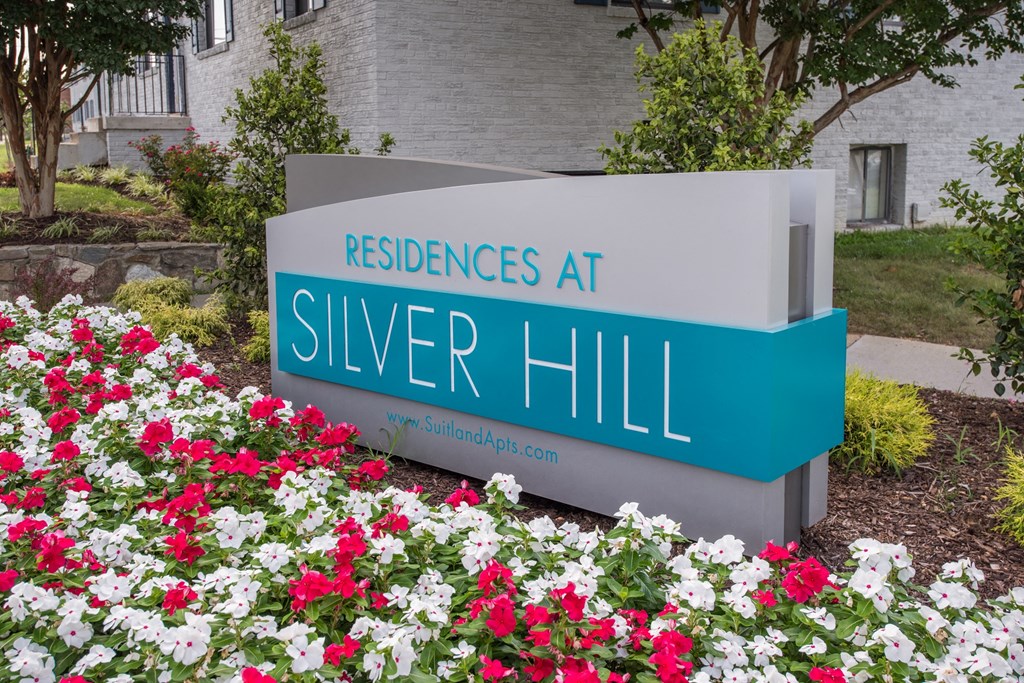 a sign that says residences at silver hill in front of flowers