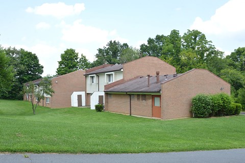 a brick house with a lawn in front of it