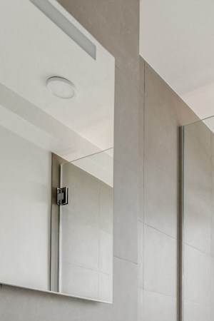 a white bathroom with a shower and a sink and a toilet