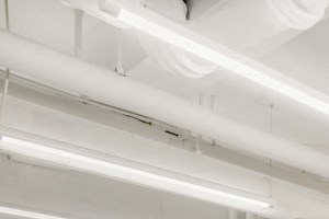 the gym with treadmills and other exercise equipment at the back of a building
