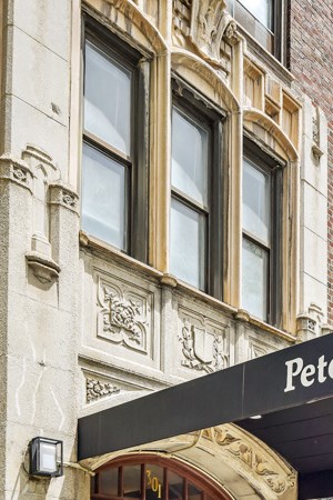 a black awning in front of a building on a sidewalk
