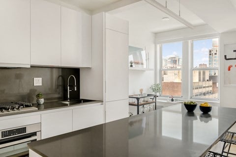 a kitchen with stainless steel counter tops and a large window
