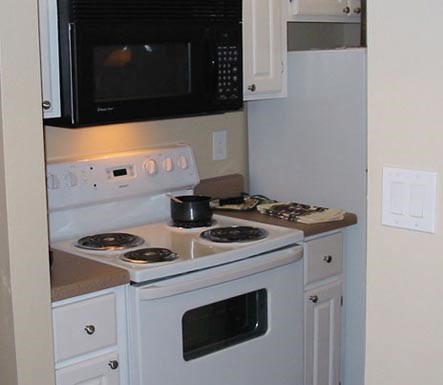 a kitchen with a stove and a microwave