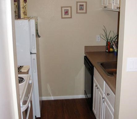 a small kitchen with a sink and a refrigerator