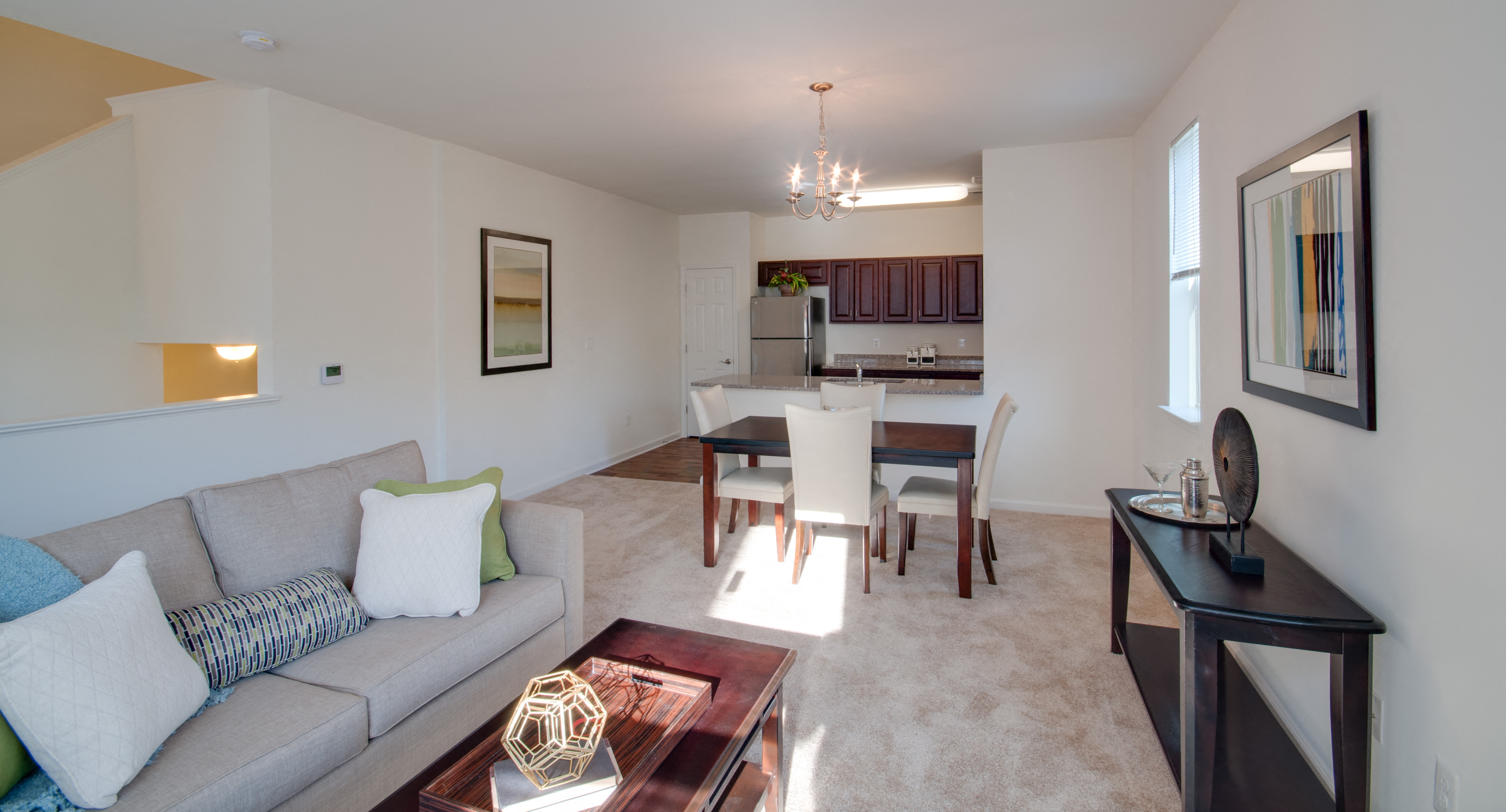 a living room and dining room with a couch and a table