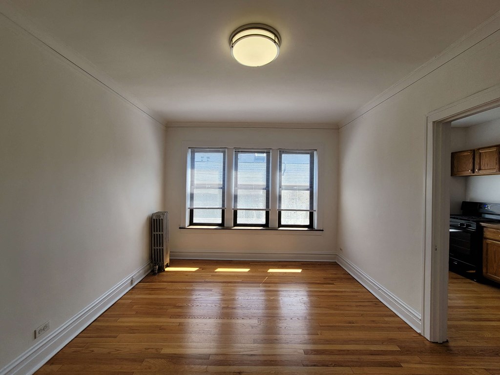 a living room with a wood floor and a window