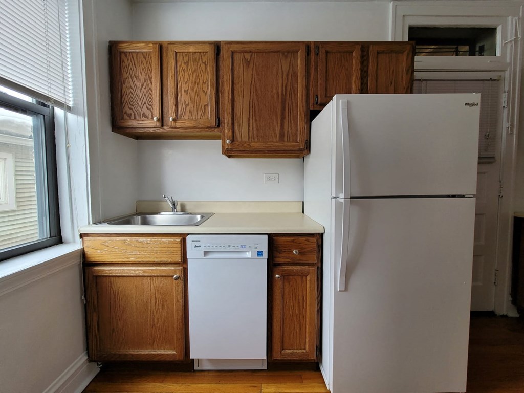 a small kitchen with a refrigerator and a sink