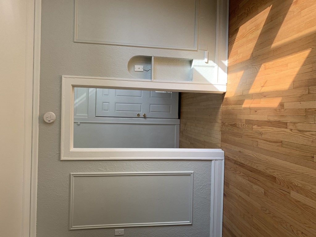 a small closet with a mirror and a door