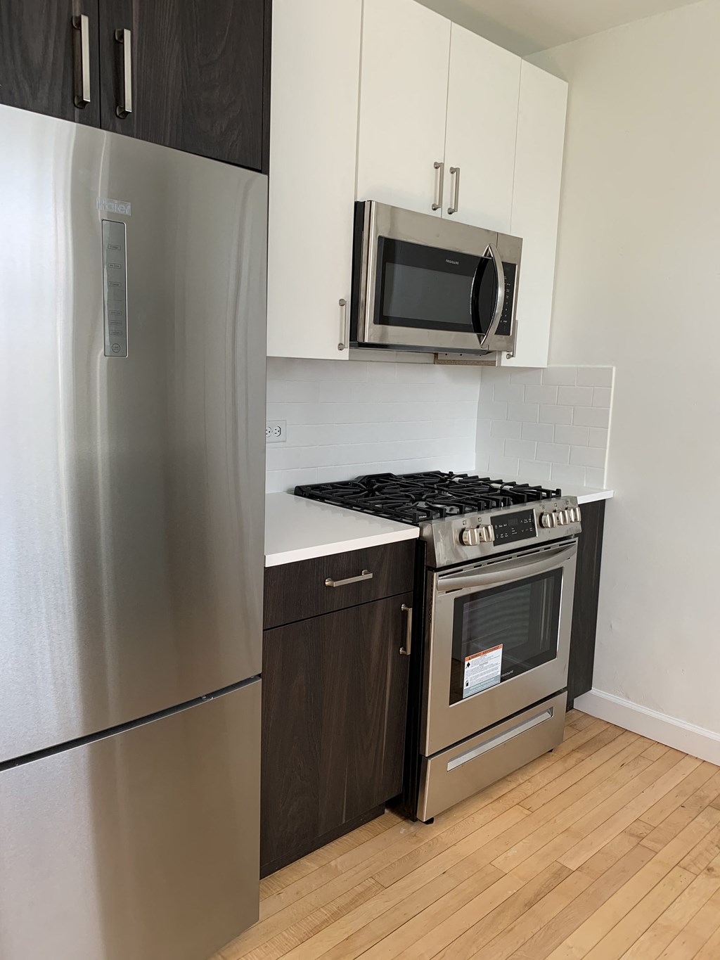 a kitchen with stainless steel appliances and a refrigerator