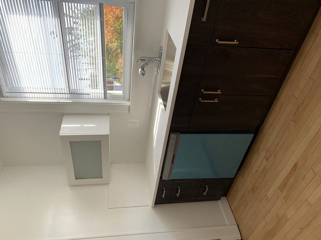 a bathroom with a shower and a sink and a mirror