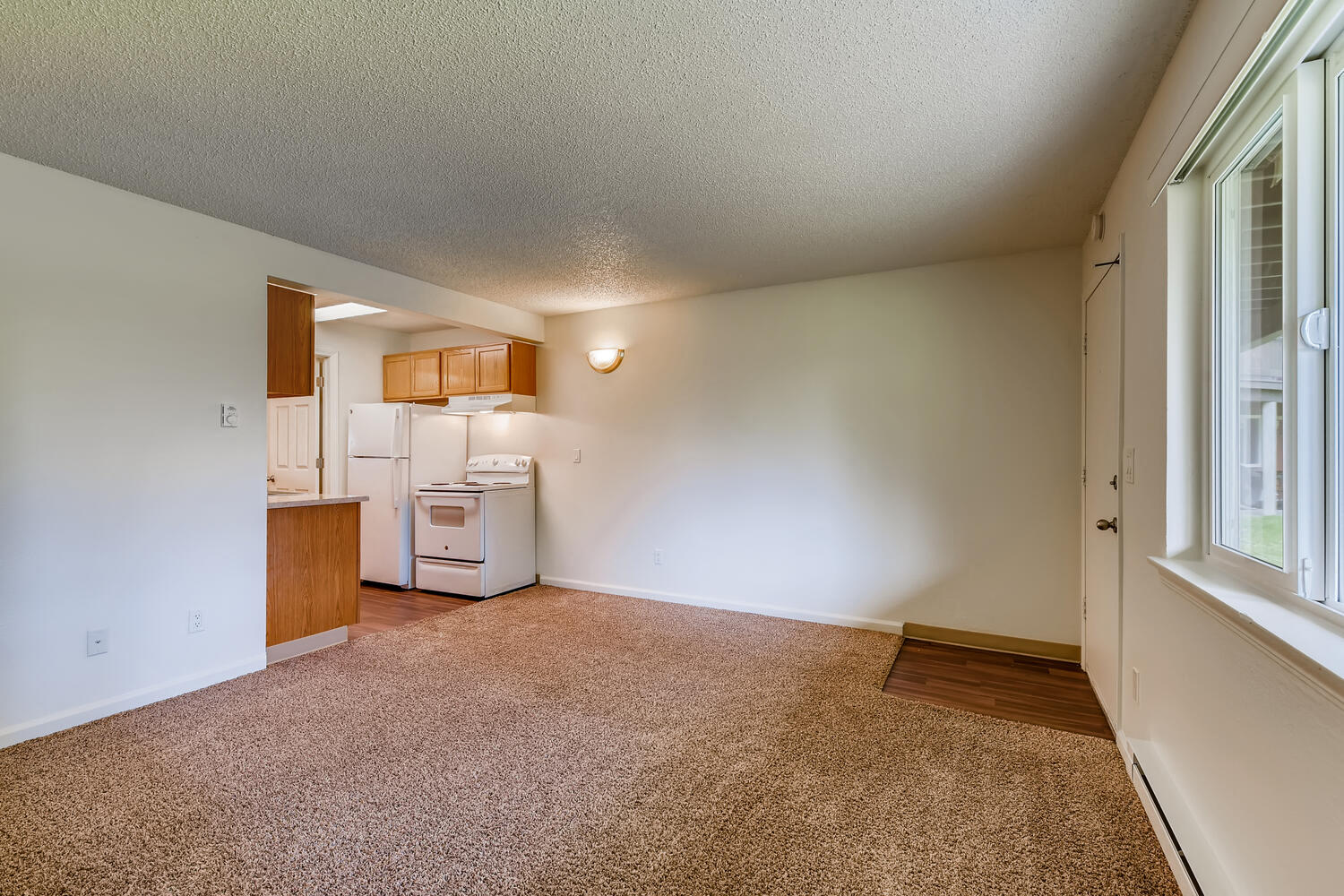 The Living Room and Kitchen in a One Bedroom Apartment at Morningtree Park Apartments