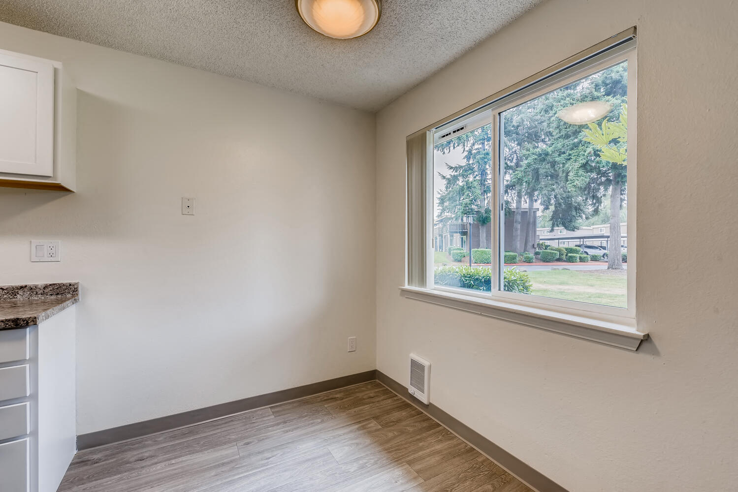 A Standard Kitchen and Window at Morningtree Park Apartments