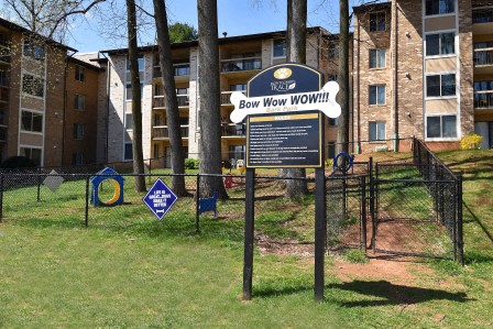 a sign in front of an apartment building