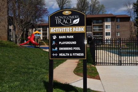 a sign for the montgomery trace activities park in front of a pool