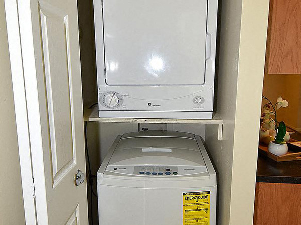 a microwave and a washing machine in a closet