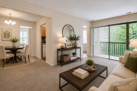 A modern living room with a dining area and a balcony.