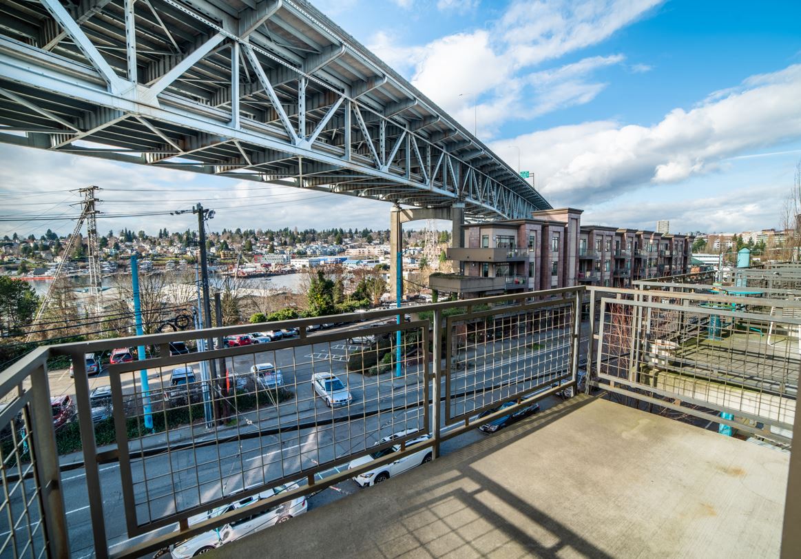 a balcony with a view of a city and a bridge