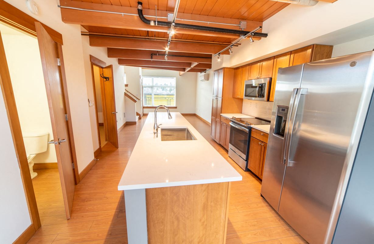 a kitchen with stainless steel appliances and a white counter top