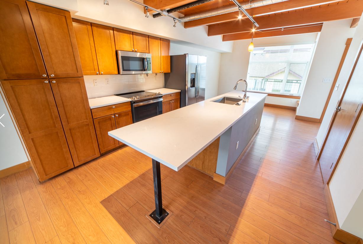 a large kitchen with a white island in the middle