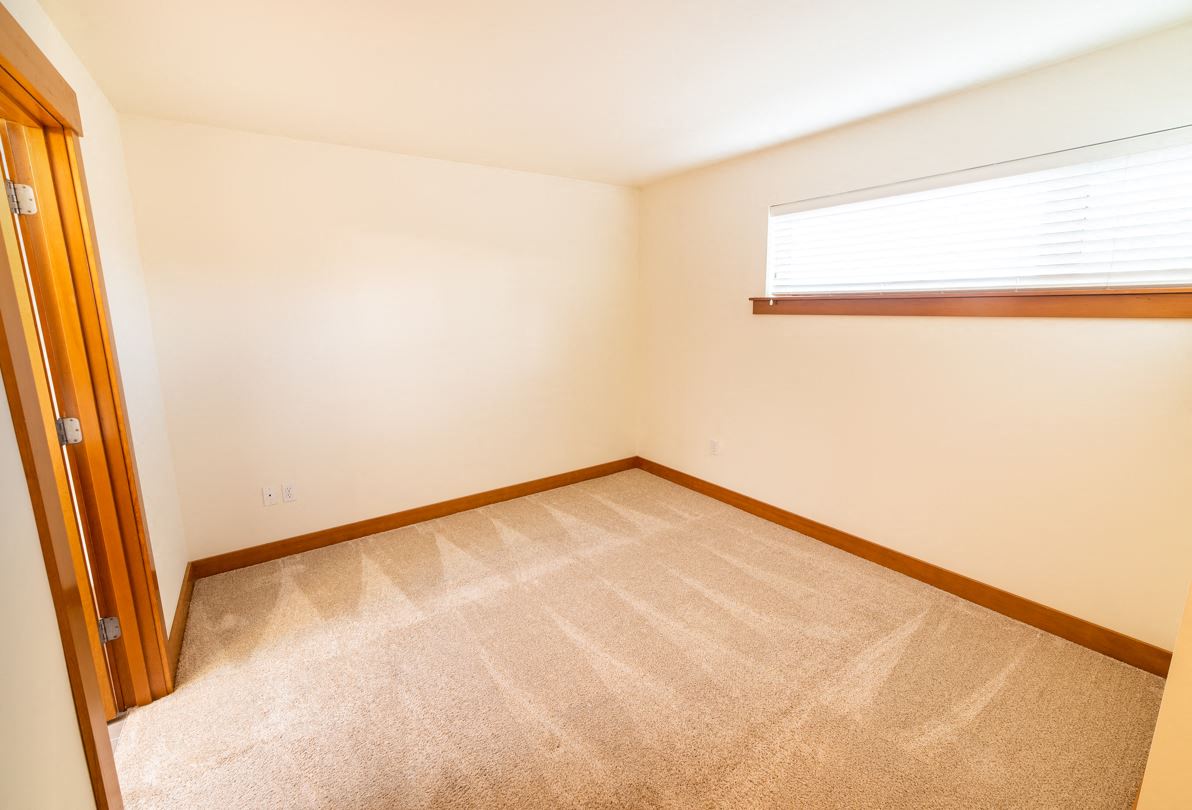 a empty room with a window and a door