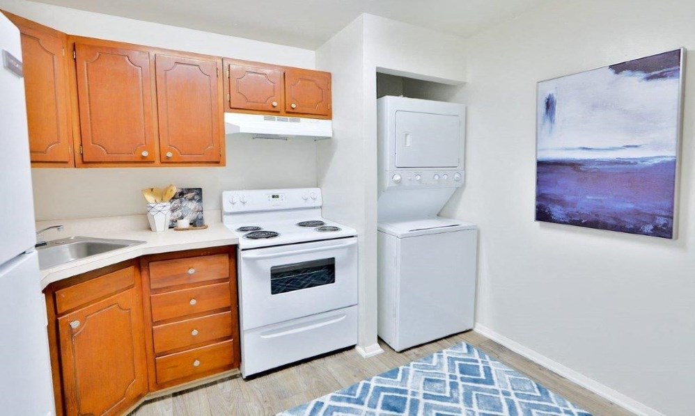 a kitchen with a stove refrigerator and a sink