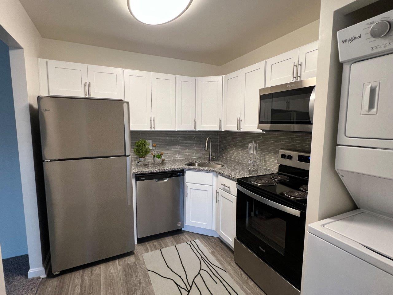 a kitchen with stainless steel appliances and white cabinets