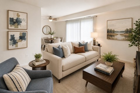 A living room with a blue couch and a white couch.