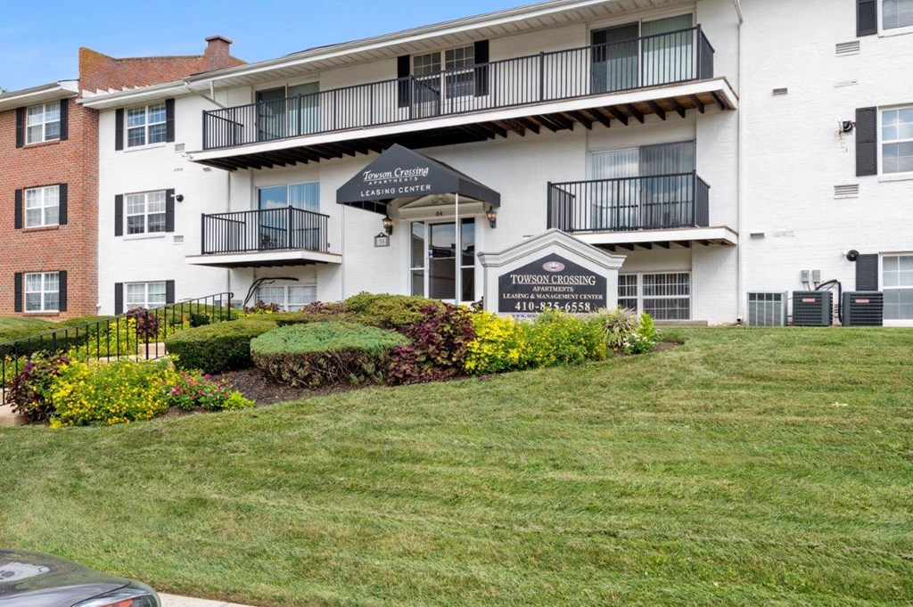 a large white building with a lawn in front of it