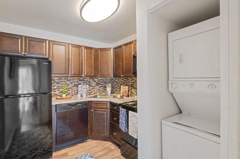 a kitchen with a washer and dryer and a refrigerator