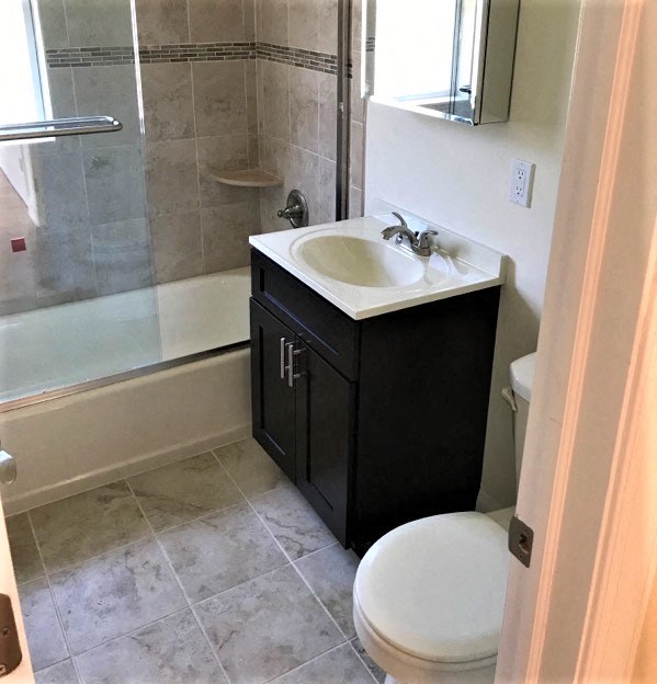 a bathroom with a sink and a toilet and a shower