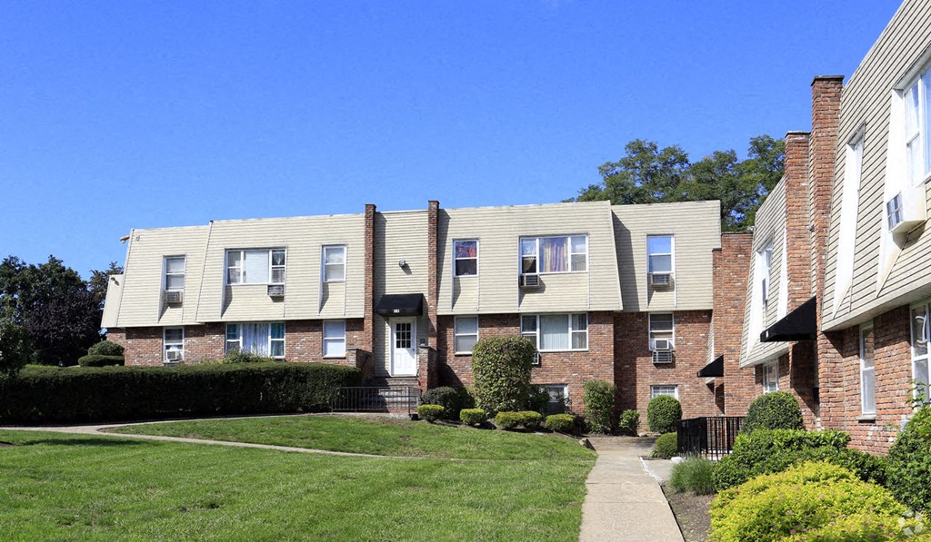 a row of apartment buildings on a sidewalk