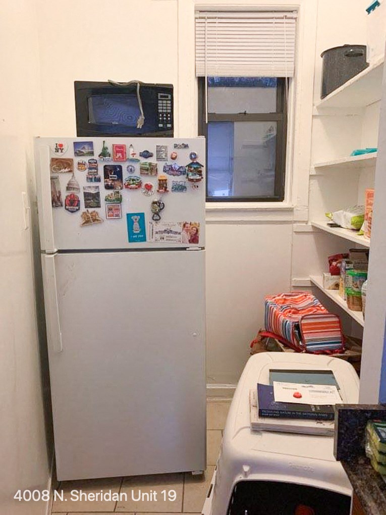a refrigerator in a kitchen with a microwave on top of it
