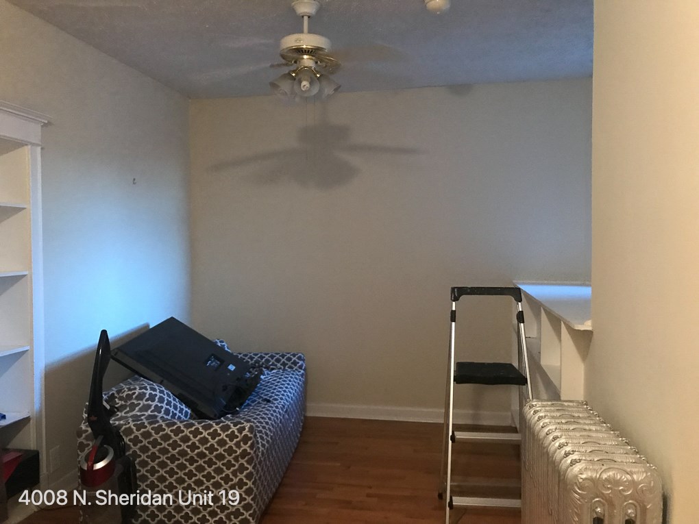 a room with a bed and a ceiling fan