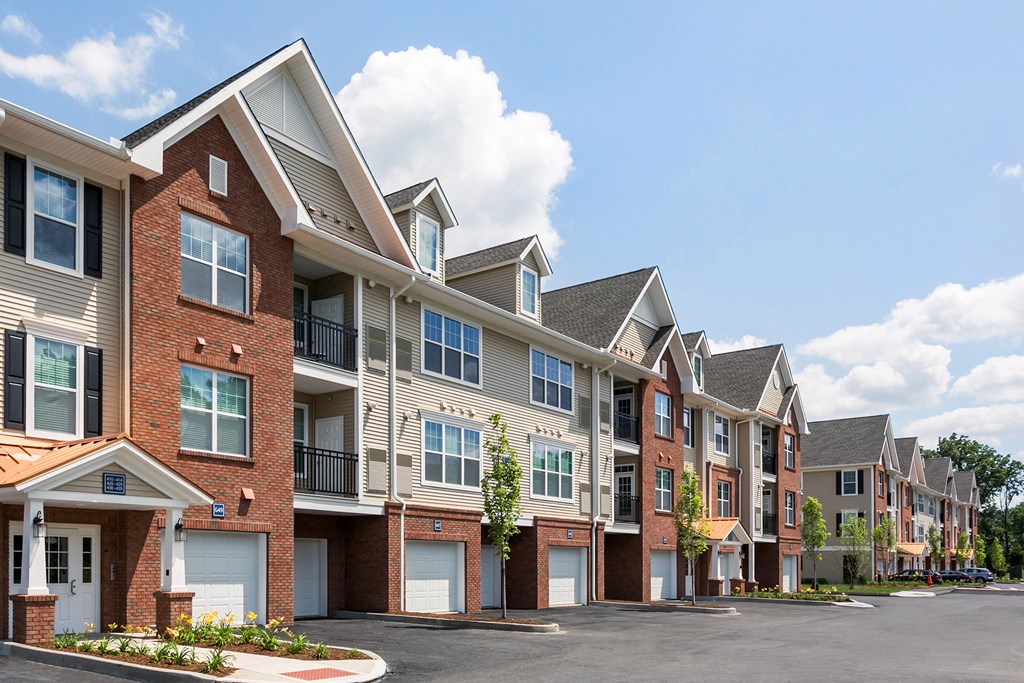 a row of brick apartment buildings with white doors
