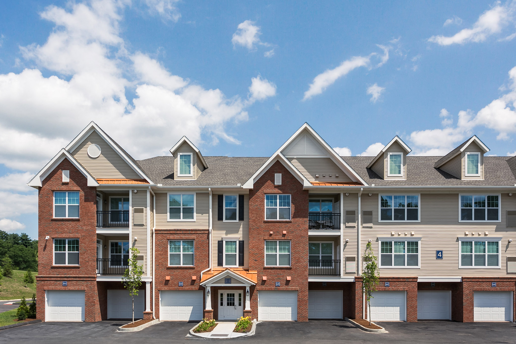 exterior of an apartment building with garage doors
