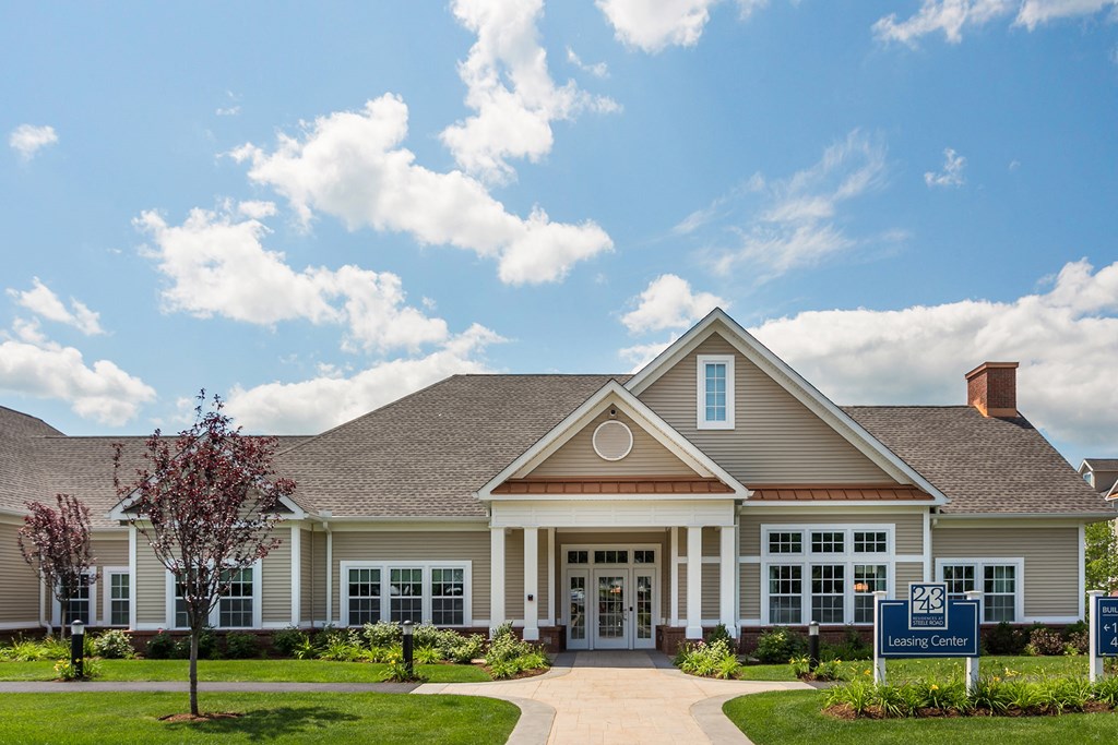 a large house with a sign in front of it