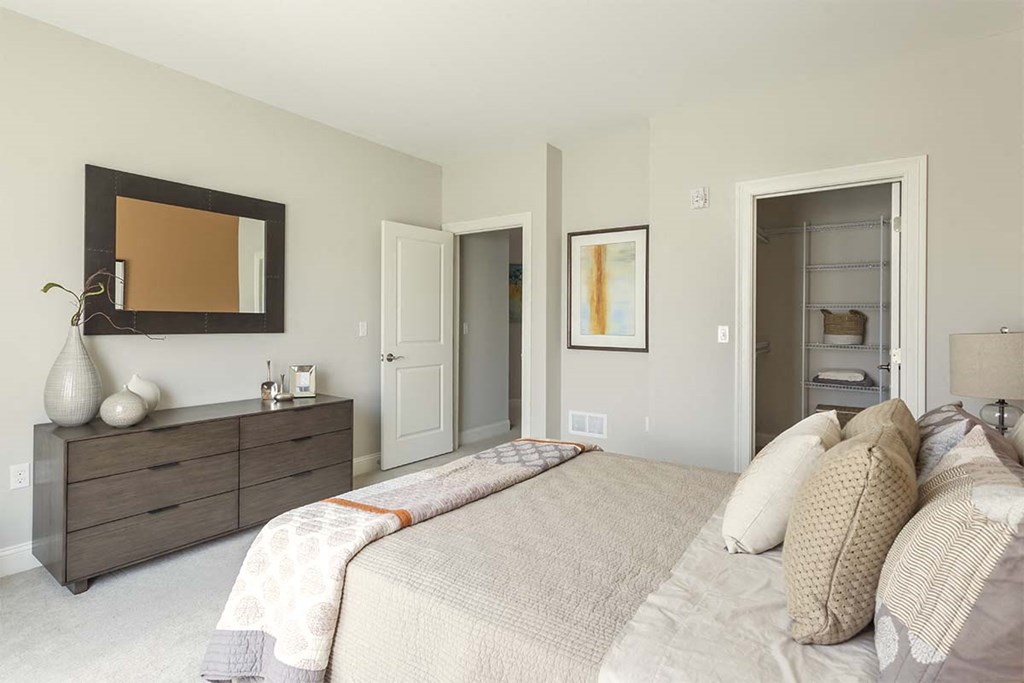 a bedroom with a large bed and a mirror