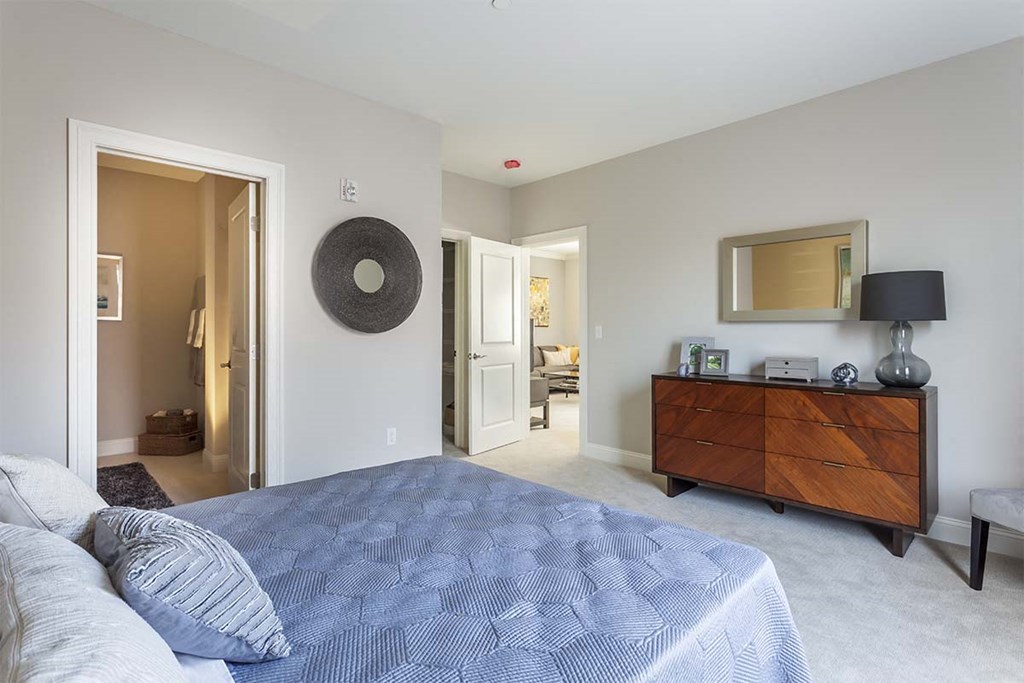 a bedroom with a bed and a dresser