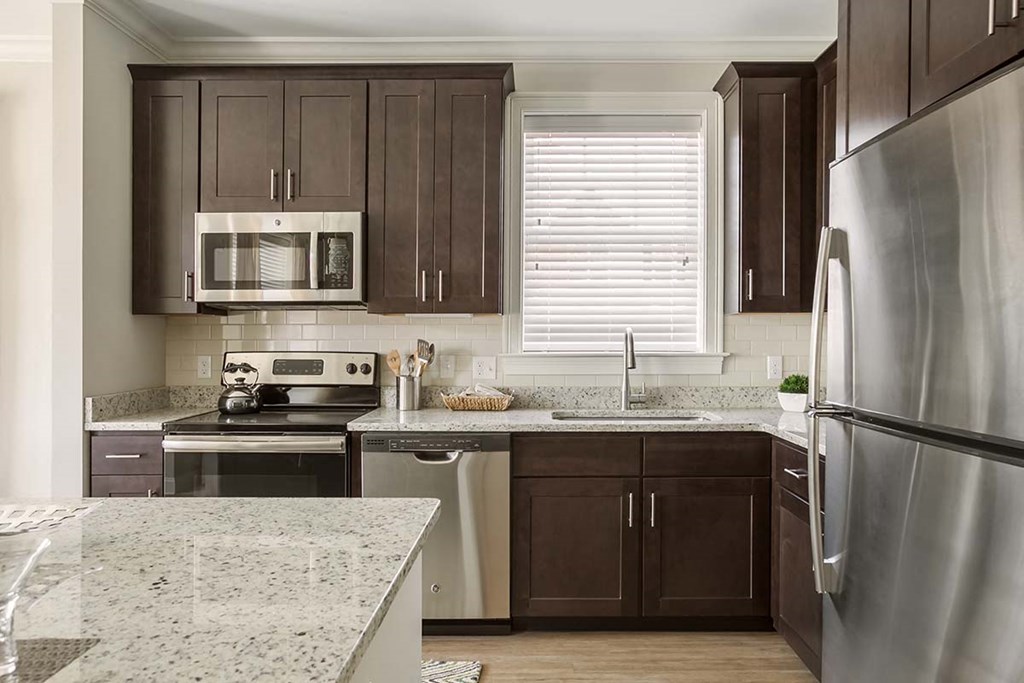 a kitchen with stainless steel appliances and granite counter tops