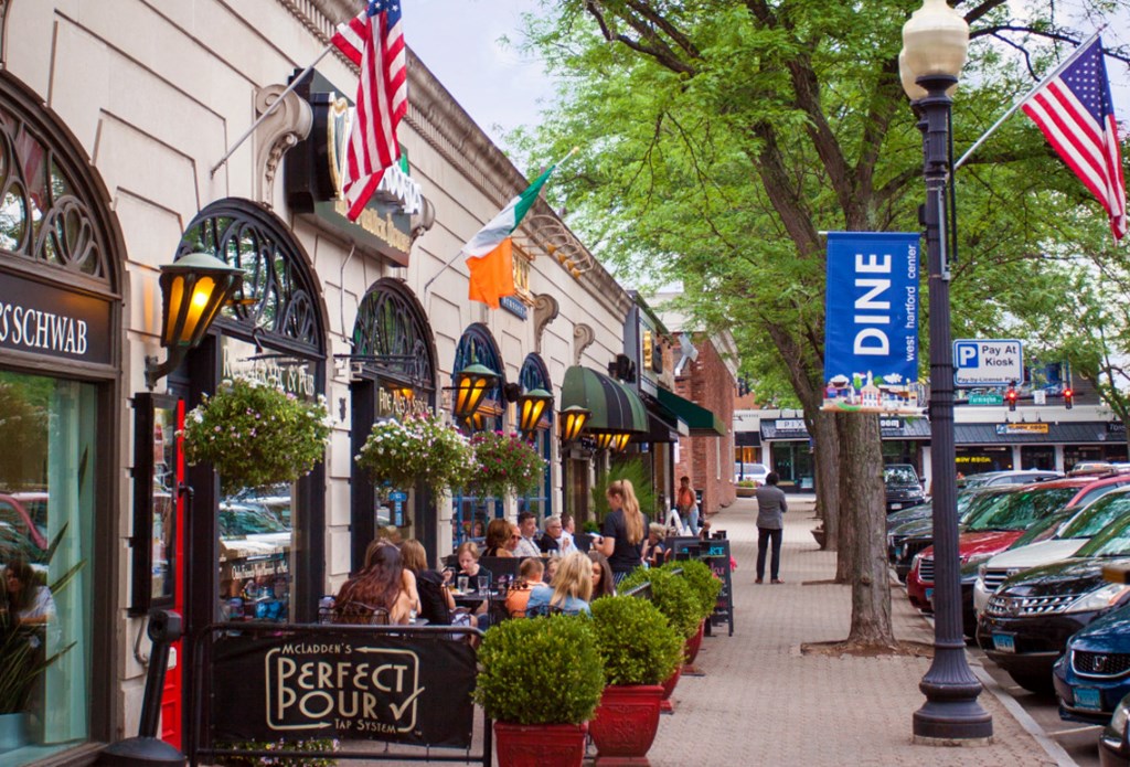 a city street filled with people and shops and cars