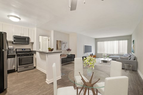 A modern kitchen with a dining table and chairs.