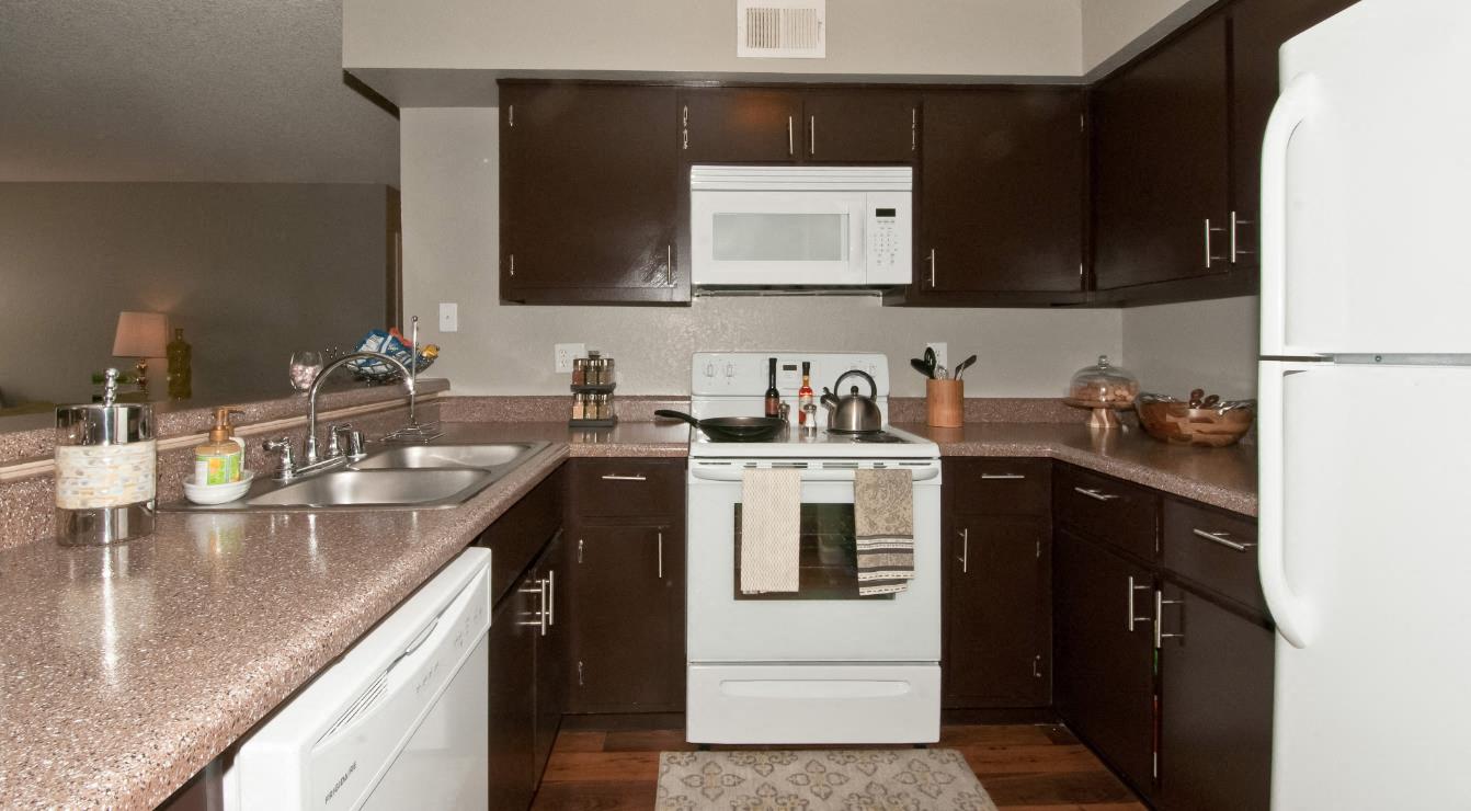 a kitchen with white appliances and granite counter tops