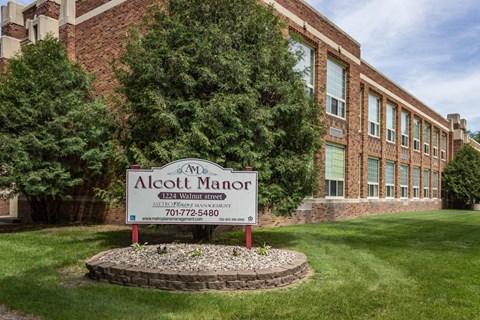 a sign in front of an apartment building