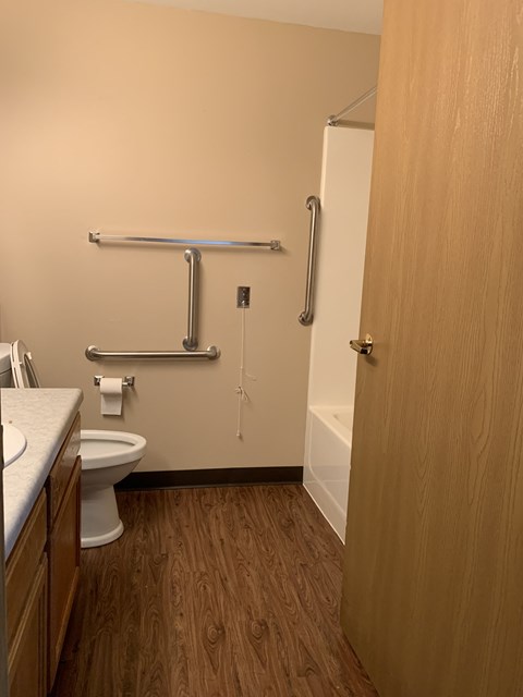 a bathroom with a toilet and a shower and a sink