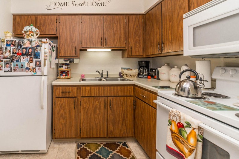 a kitchen with white appliances and wooden cabinets