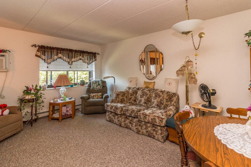 a living room with a couch and a dining table