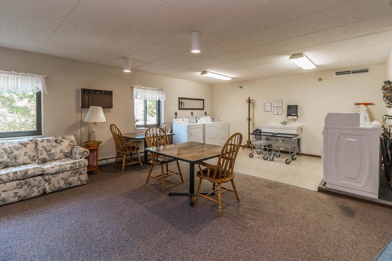 a living room with a dining room table and a couch
