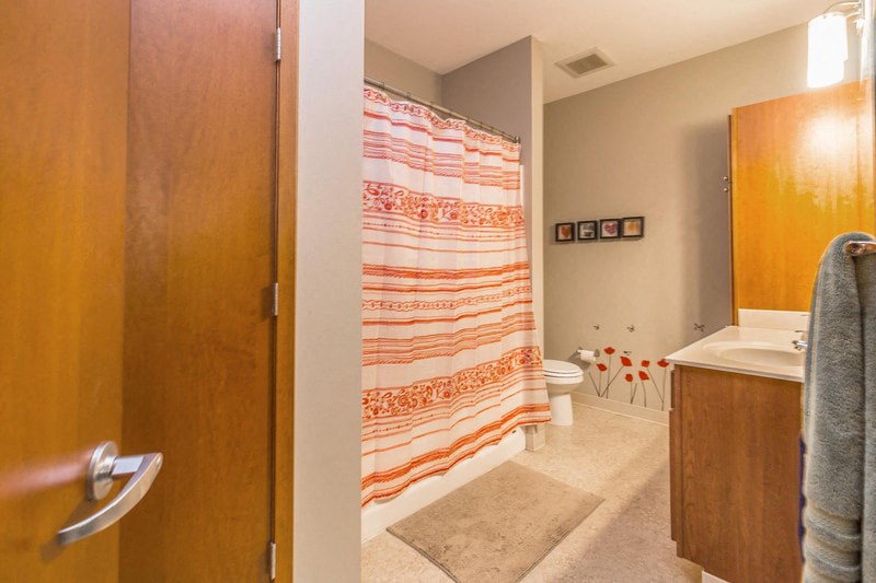 a bathroom with a shower curtain and a toilet in it