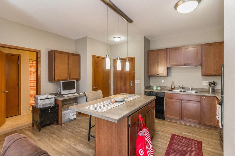 a kitchen and living room with an island and a table
