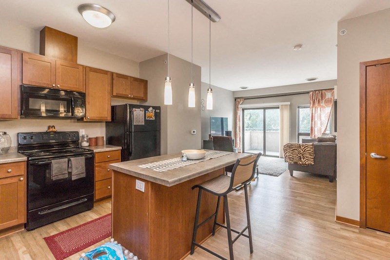 a kitchen with a center island with two stools